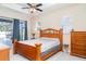 Bedroom featuring a view of the pool, tray ceiling and ceiling fan at 7581 Palmer Glen Cir, Sarasota, FL 34240