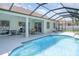 Gorgeous pool features screened enclosure, covered patio, and outdoor grill at 7581 Palmer Glen Cir, Sarasota, FL 34240