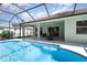Beautiful pool and patio area with screened enclosure and outdoor dining space at 7581 Palmer Glen Cir, Sarasota, FL 34240