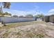 Expansive backyard featuring white vinyl fencing and lush greenery, perfect for outdoor activities and privacy at 9143 Dream Way, Largo, FL 33773