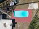 Aerial view of a rectangular in-ground swimming pool with a red concrete deck and a white liner at 9143 Dream Way, Largo, FL 33773