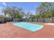 Inviting backyard showcasing a private pool, patio, storage shed, and partial fence at 9143 Dream Way, Largo, FL 33773