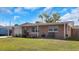 A single-story home with a well-maintained lawn, showcasing its inviting facade and outdoor charm at 9301 Pegasus Ave, Port Richey, FL 34668