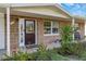 Inviting front porch with a decorative door, colorful landscaping, and charming design at 9301 Pegasus Ave, Port Richey, FL 34668