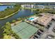 An aerial shot features tennis courts, a swimming pool, and a scenic lake for relaxation and recreation at 10038 62Nd N Ter # 21, St Petersburg, FL 33708
