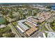 Aerial view highlighting a residential complex nestled amidst lush greenery with nearby water features at 10038 62Nd N Ter # 21, St Petersburg, FL 33708