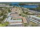 Comprehensive aerial view displaying the residential complex adjacent to a tranquil bay and lush landscaping at 10038 62Nd N Ter # 21, St Petersburg, FL 33708