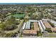 Aerial view features a residential complex near a picturesque lake and Redington Shores Beach at 10038 62Nd N Ter # 21, St Petersburg, FL 33708