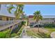 Exterior view of a two-story apartment building with palm trees and well-kept landscaping at 10038 62Nd N Ter # 21, St Petersburg, FL 33708
