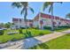 Well-maintained condo complex with lush landscaping and mature palm trees on a bright sunny day at 10038 62Nd N Ter # 21, St Petersburg, FL 33708