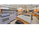 Spacious kitchen featuring an island, double sink, and ample cabinetry, perfect for culinary enthusiasts at 10038 62Nd N Ter # 21, St Petersburg, FL 33708
