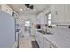 Kitchen featuring white appliances, cabinets, and countertops with a view to the living room at 10038 62Nd N Ter # 21, St Petersburg, FL 33708