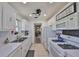 Bright kitchen featuring white cabinets and appliances adjacent to the dining area at 10038 62Nd N Ter # 21, St Petersburg, FL 33708