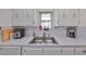 Bright kitchen with stainless steel sink and faucet featuring lots of natural light and ample cabinets at 10038 62Nd N Ter # 21, St Petersburg, FL 33708