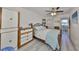 Comfortable main bedroom with queen-sized bed, ceiling fan, wood accents and bright light at 10038 62Nd N Ter # 21, St Petersburg, FL 33708