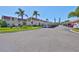 Well-maintained complex with manicured lawns, covered parking, and tropical palm trees on a clear day at 10038 62Nd N Ter # 21, St Petersburg, FL 33708