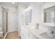 Modern bathroom with dual sinks, white vanity, framed mirrors, and glass-enclosed shower at 11310 Grand Winthrop Ave, Riverview, FL 33578