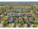 Aerial view of a community with waterfront properties, featuring serene lakes and tree-lined streets at 14605 Chatsworth Manor Cir, Tampa, FL 33626