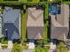 Overhead view of a home with a geometric roof, adjacent to a pool and bordered by green lawns at 14605 Chatsworth Manor Cir, Tampa, FL 33626