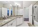 Bright bathroom with granite countertop, tub and shower, and white cabinets at 14605 Chatsworth Manor Cir, Tampa, FL 33626