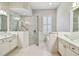 Bright bathroom with dual vessel sinks, shower and separate tub at 14605 Chatsworth Manor Cir, Tampa, FL 33626