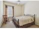 Bedroom with a metal frame bed and plush neutral carpet at 14605 Chatsworth Manor Cir, Tampa, FL 33626