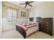 Cozy bedroom with dark wood furnishings and bright window at 14605 Chatsworth Manor Cir, Tampa, FL 33626