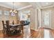 Formal dining area with decorative wallpaper, chandelier, and hardwood flooring at 14605 Chatsworth Manor Cir, Tampa, FL 33626