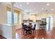 Bright, open kitchen featuring a breakfast nook, white cabinets, and hardwood floors at 14605 Chatsworth Manor Cir, Tampa, FL 33626
