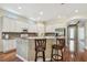 Spacious kitchen featuring white cabinets, granite countertops, a breakfast bar, and modern appliances at 14605 Chatsworth Manor Cir, Tampa, FL 33626
