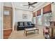 Cozy living room with a comfortable couch, natural light, and a ceiling fan at 14605 Chatsworth Manor Cir, Tampa, FL 33626