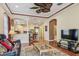 Open living room with hardwood floors flows into kitchen with breakfast bar and modern appliances at 14605 Chatsworth Manor Cir, Tampa, FL 33626