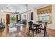 Open-concept living and dining space featuring hardwood floors and lots of natural light at 14605 Chatsworth Manor Cir, Tampa, FL 33626