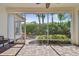Screened patio with brick pavers overlooks lush backyard at 14605 Chatsworth Manor Cir, Tampa, FL 33626