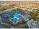 Community pool and tennis courts surrounded by lush landscaping and well-maintained grounds at 14605 Chatsworth Manor Cir, Tampa, FL 33626
