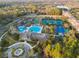 Aerial view showcases resort-style amenities, including pool, tennis courts, and a playground at 14605 Chatsworth Manor Cir, Tampa, FL 33626