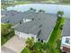 Aerial view of a home with a three car garage, manicured landscaping and beautiful water view at 14610 Red Castle Ave, Lithia, FL 33547