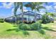 The backyard features a screened-in pool area, privacy fence, and tropical landscaping at 14610 Red Castle Ave, Lithia, FL 33547