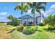 Lush landscaping and palm trees surround the screened-in pool and patio area in the backyard at 14610 Red Castle Ave, Lithia, FL 33547