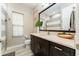 Bathroom featuring a dark wood vanity, large mirror, tile flooring, and shower at 14610 Red Castle Ave, Lithia, FL 33547