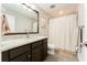 Charming bathroom featuring modern lighting, a vanity with a marble countertop, and a shower with elegant tile work at 14610 Red Castle Ave, Lithia, FL 33547