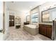 Bright bathroom featuring dual vanities, soaking tub, and a separate walk-in closet at 14610 Red Castle Ave, Lithia, FL 33547