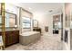 Bright bathroom featuring dual vanities, soaking tub, and a separate walk-in closet at 14610 Red Castle Ave, Lithia, FL 33547