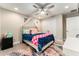 Bedroom featuring a ceiling fan, canopy bed, patterned rug, and neutral paint at 14610 Red Castle Ave, Lithia, FL 33547