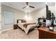 Bedroom featuring a ceiling fan, dresser, neutral paint, desk, and carpet flooring at 14610 Red Castle Ave, Lithia, FL 33547