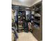 A walk-in closet featuring built-in shelving with clothing racks, shelves and space for storage at 14610 Red Castle Ave, Lithia, FL 33547
