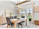 Dining area featuring wood floors, modern chandelier, natural light, and neutral accents at 14610 Red Castle Ave, Lithia, FL 33547