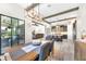 View of a dining room featuring a wood table set, stylish lighting and open floor plan connecting to the living room at 14610 Red Castle Ave, Lithia, FL 33547