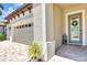 Close up of beautiful exterior elevation with a large driveway, two car garage, and tropical landscaping at 14610 Red Castle Ave, Lithia, FL 33547