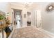 Bright foyer with decorative rug, contemporary light fixture, and views of the open living spaces at 14610 Red Castle Ave, Lithia, FL 33547